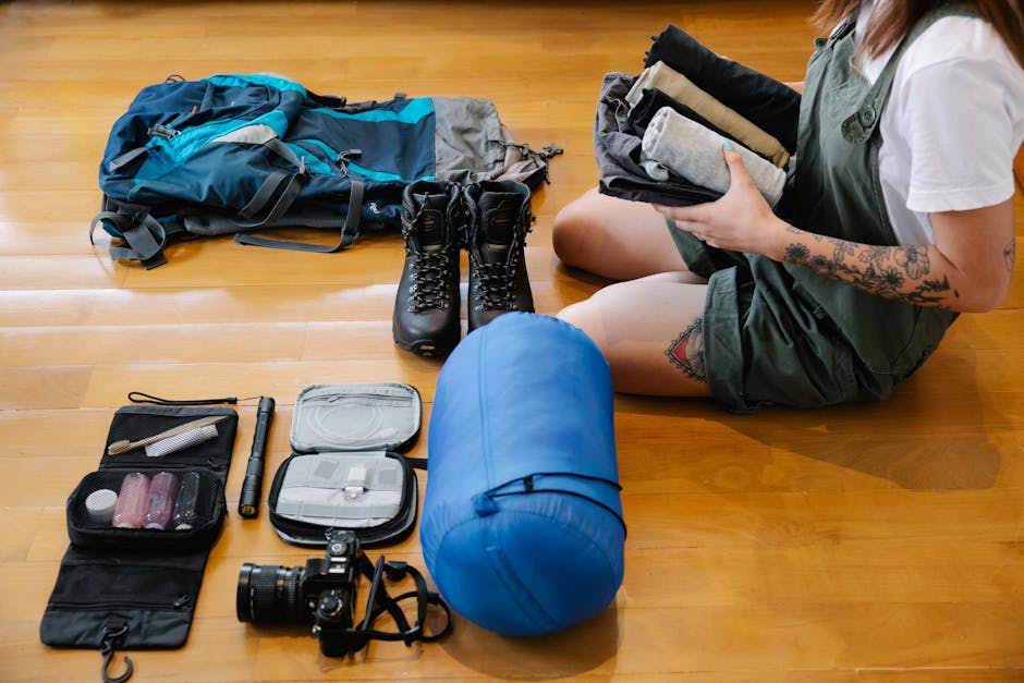 Backpacker laying out travel gear and clothing for a trip