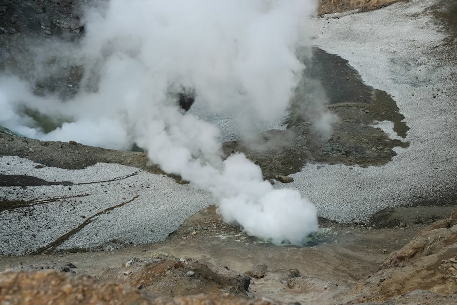Geothermal steam vents and craters in a volcanic landscape