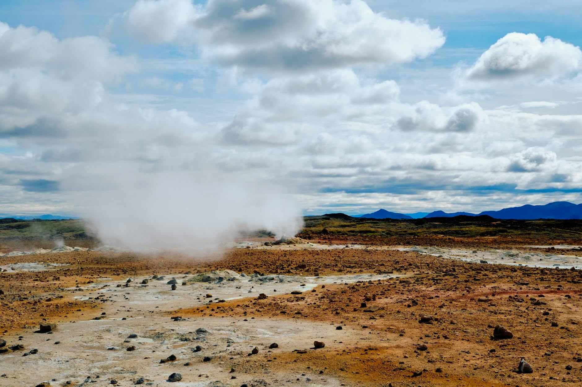 Geothermal hot springs with steam rising from mineral-rich waters