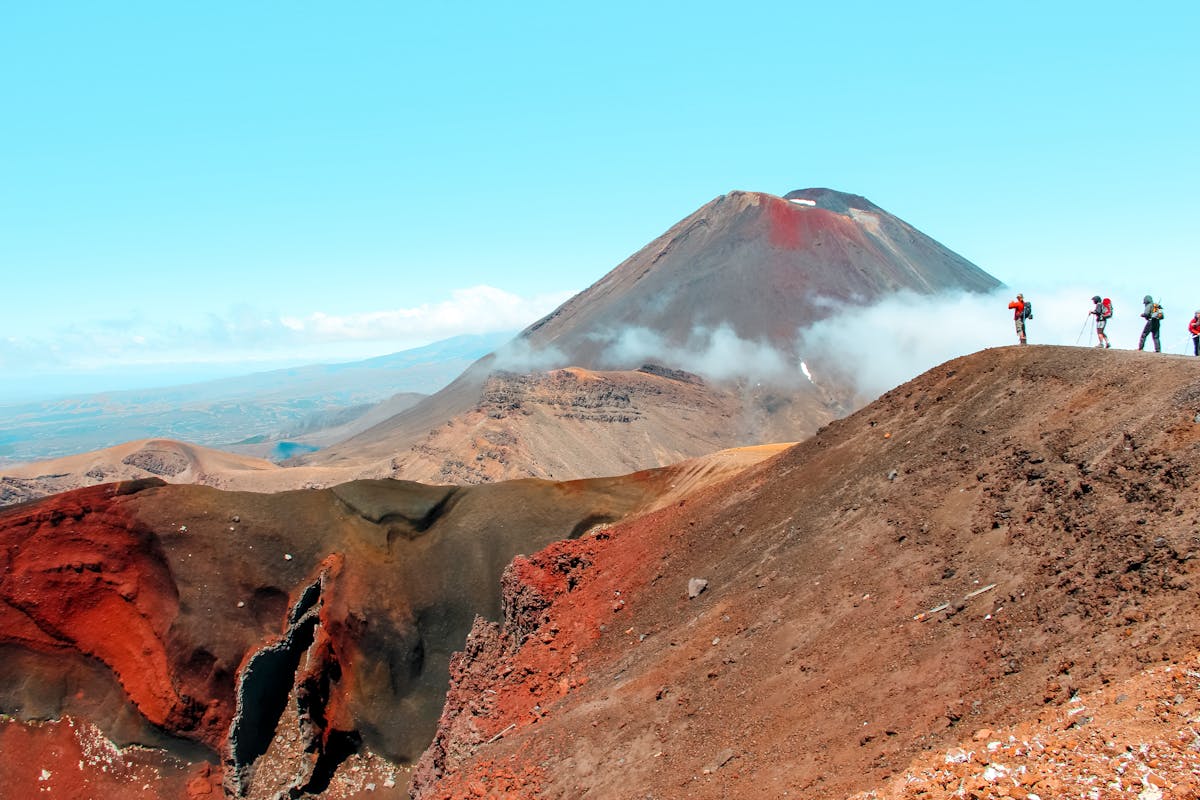 Hikers near Mount Ngauruhoe volcanic landscape in Tongariro National Park New Zealand