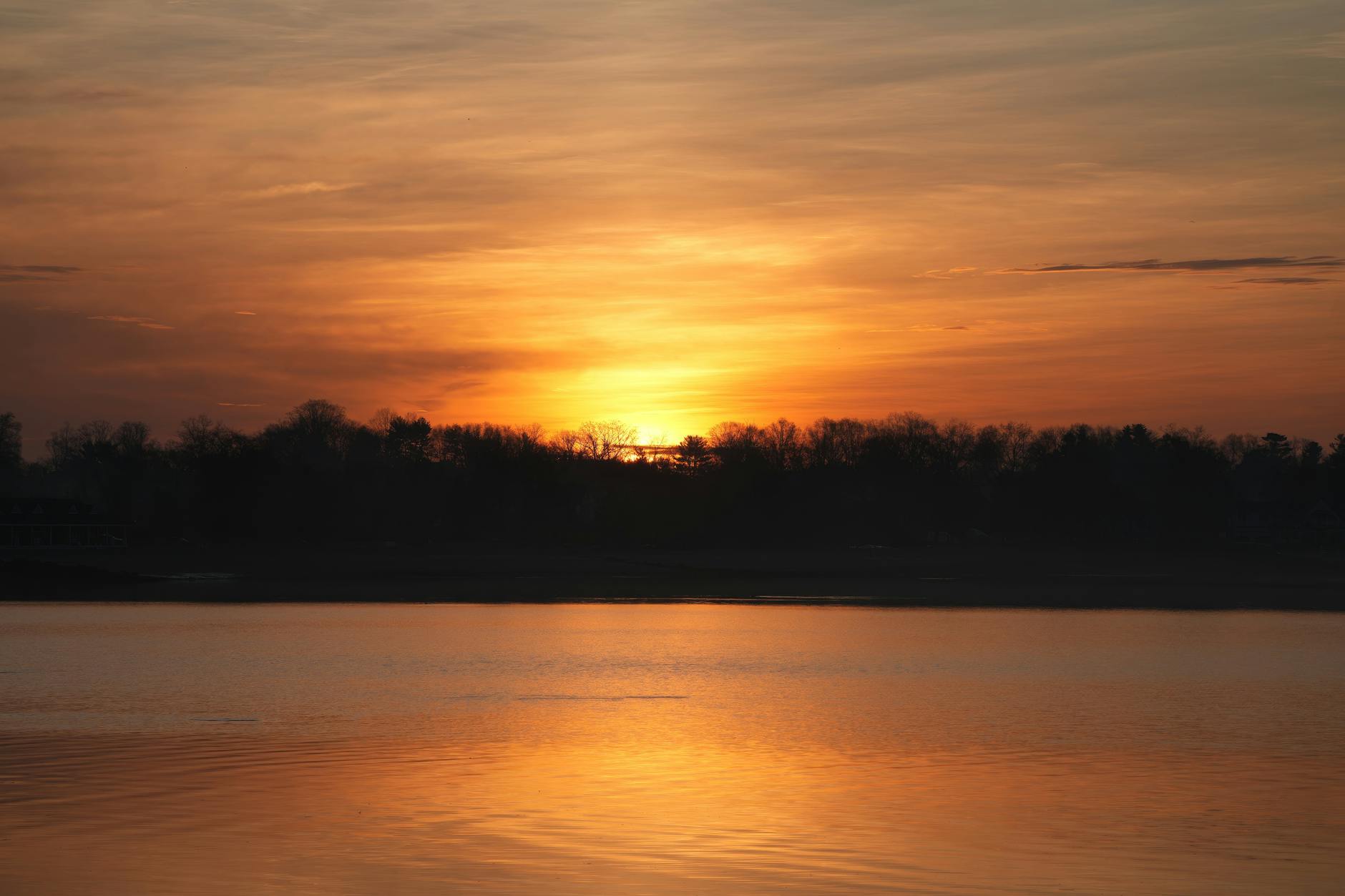 Golden sunset over a lake creating stunning reflections on the water
