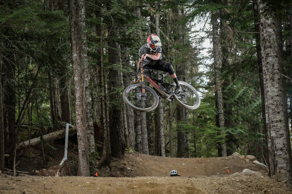 Mountain biker riding through a forest trail