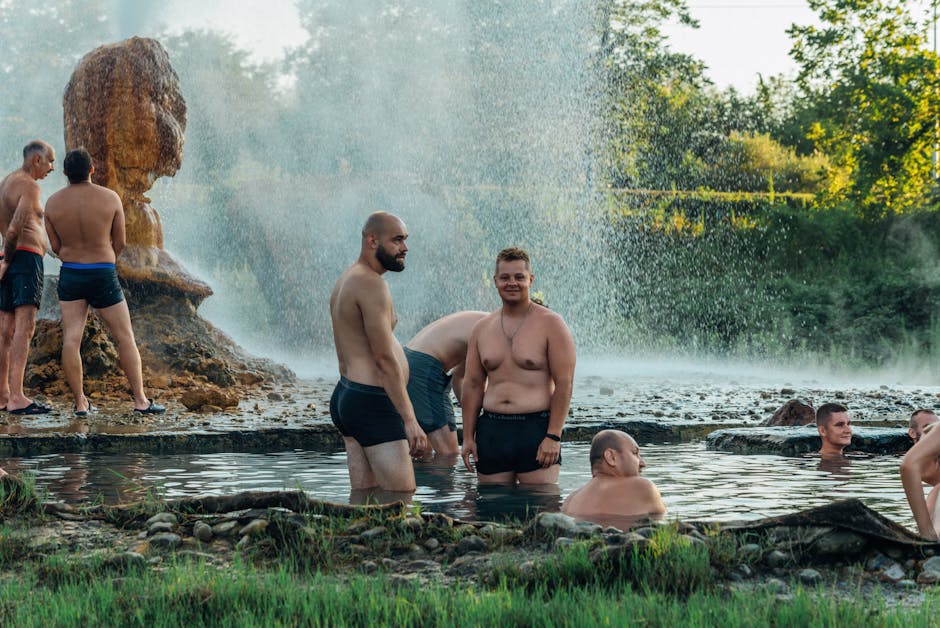 People relaxing in a natural hot spring by a river