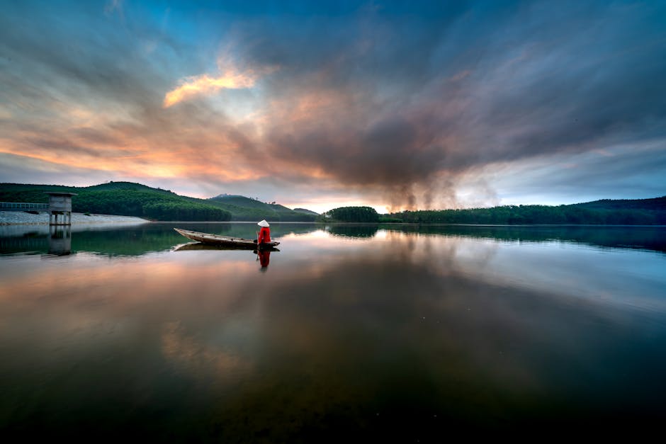 Peaceful solo morning by a lake with mist and reflections