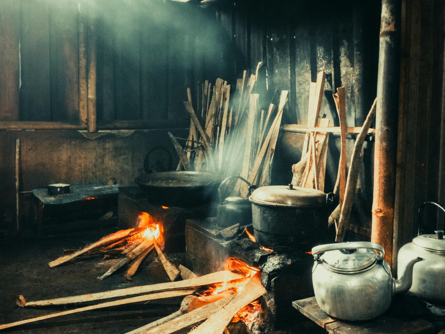 Travellers cooking together in a bright hostel communal kitchen