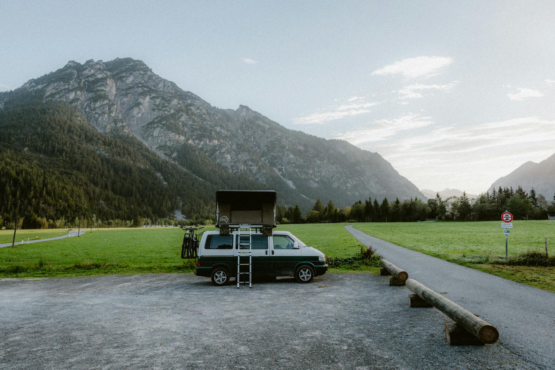 Campervan traveling on a scenic New Zealand road near mountains