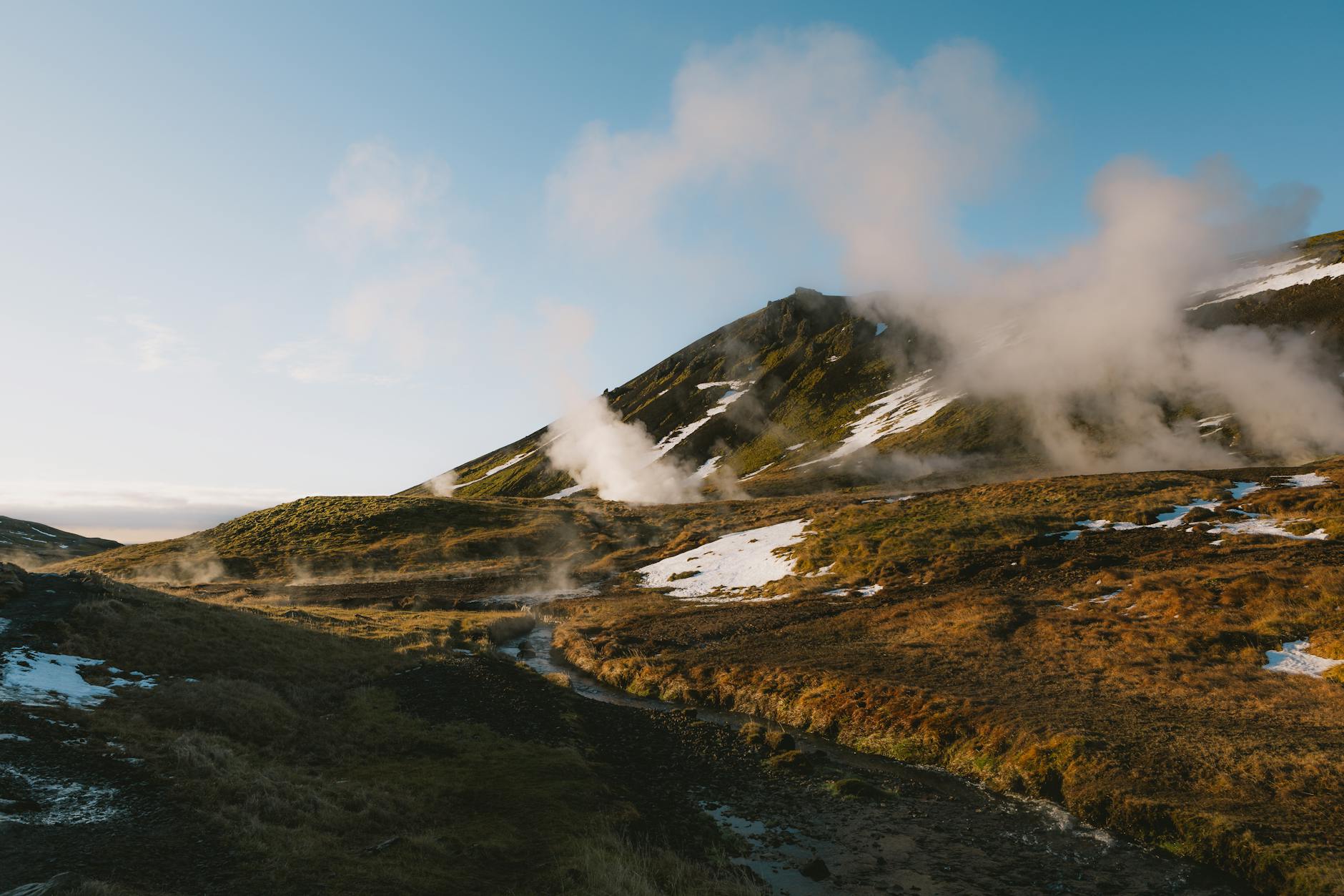 Panoramic volcanic landscape with steam vents and mountains in New Zealand