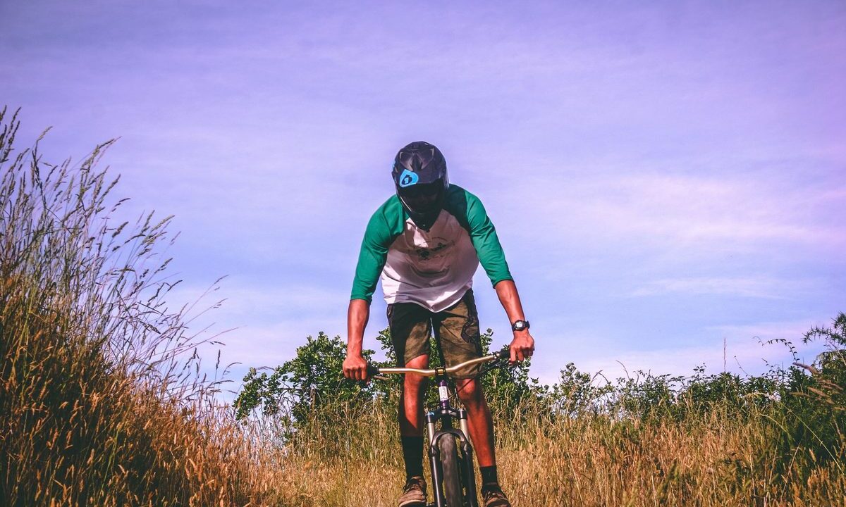 Mountain biker pausing on an open trail in New Zealand