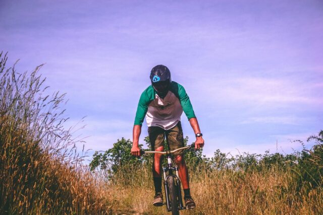 Mountain biker pausing on an open trail in New Zealand