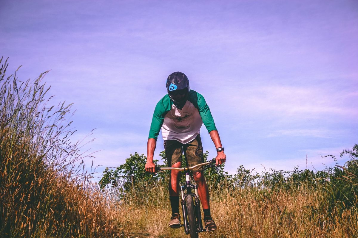 Mountain biker pausing on an open trail in New Zealand