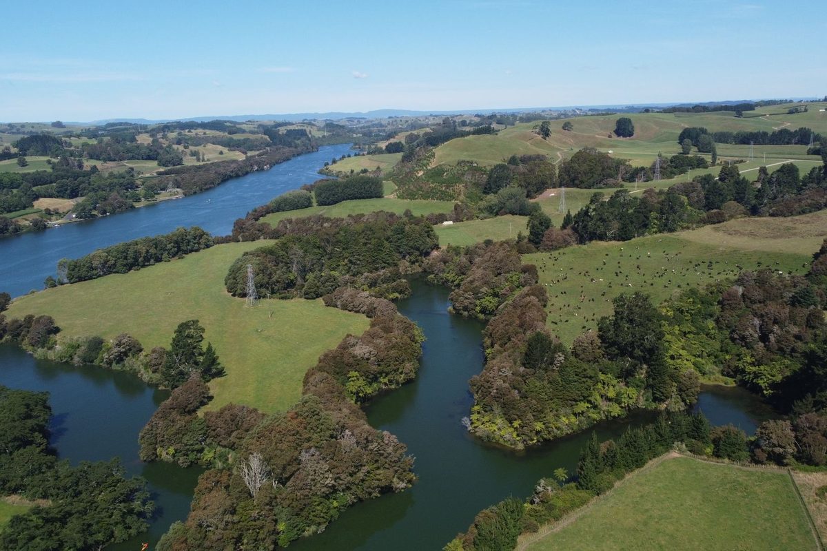 The Waikato River winding through farmland, the same river that flows over Huka Falls